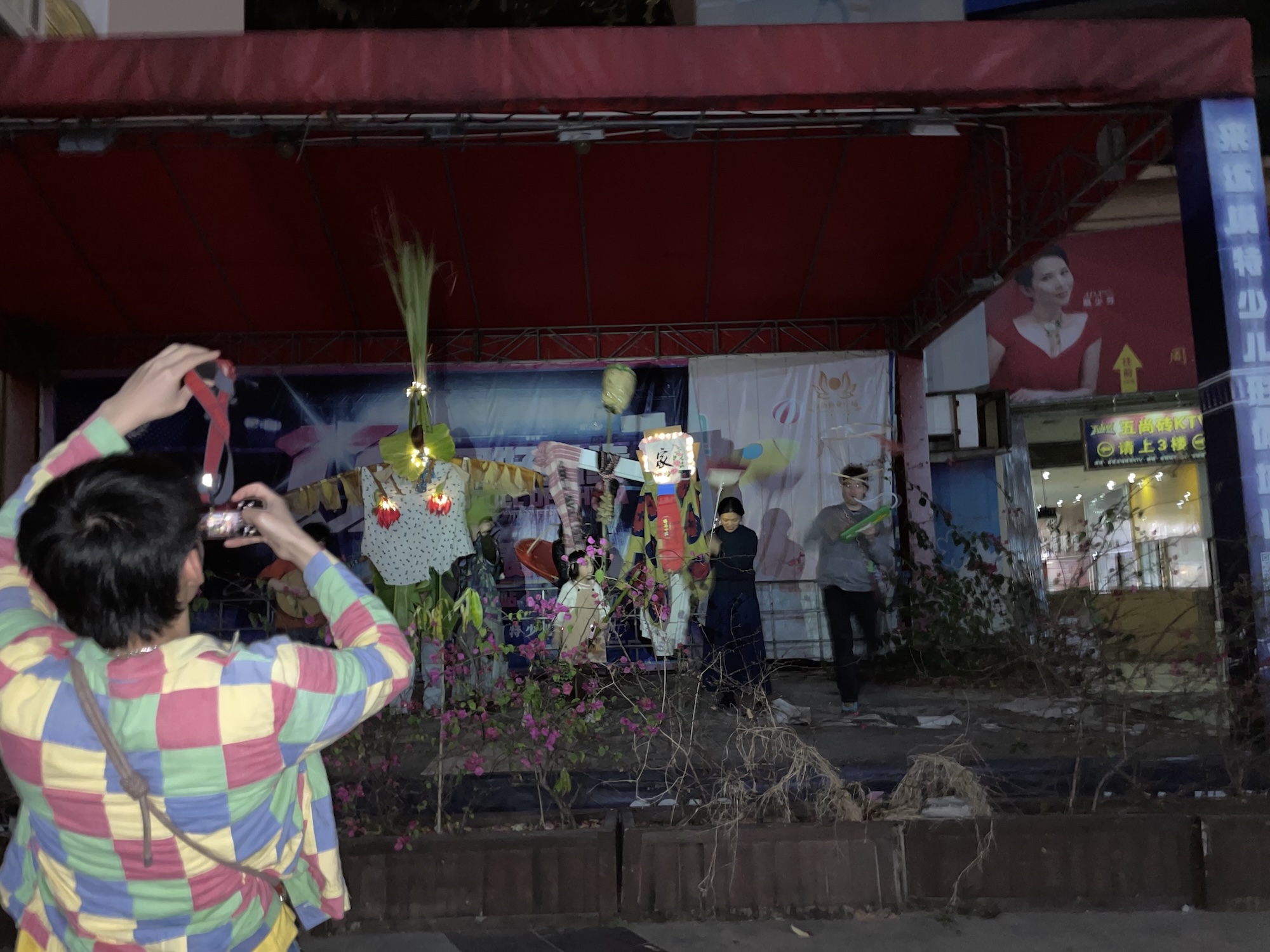 Group of young artists standing on a stage in abandonned architecture with puppets